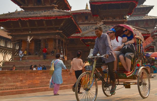 Tourist enjoying rickshaw ride in Kathmandu durbar square in Nepal tour