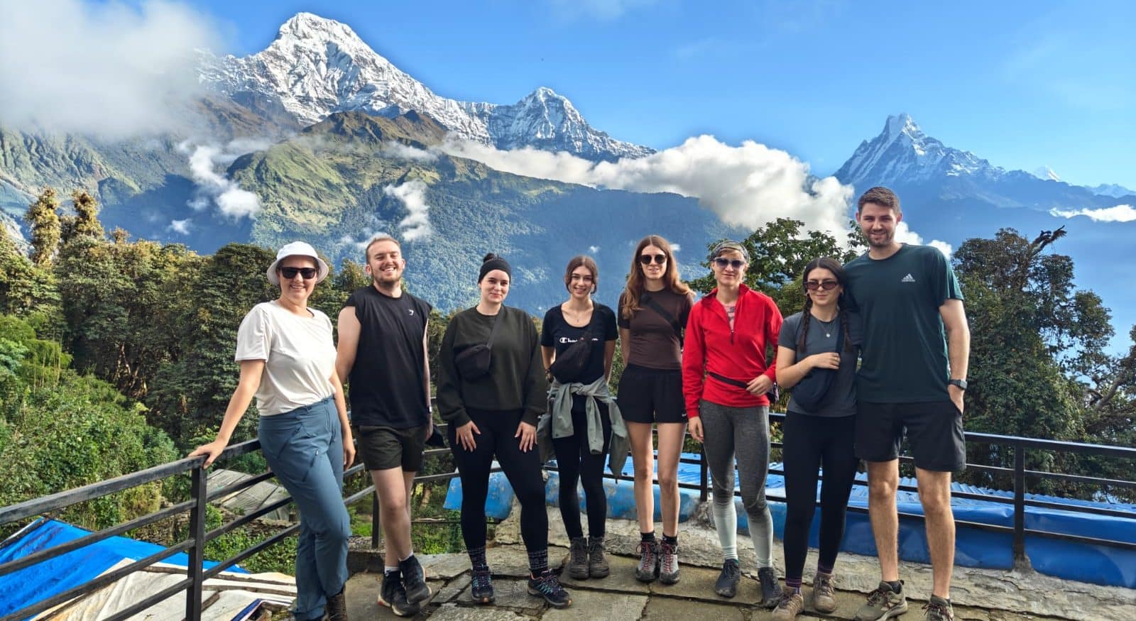 Group of trekkers posing infront of fishtail mountain