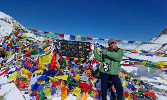 Female trekker at Thorong La Pass 5416m — Annapurna Circuit Nepal