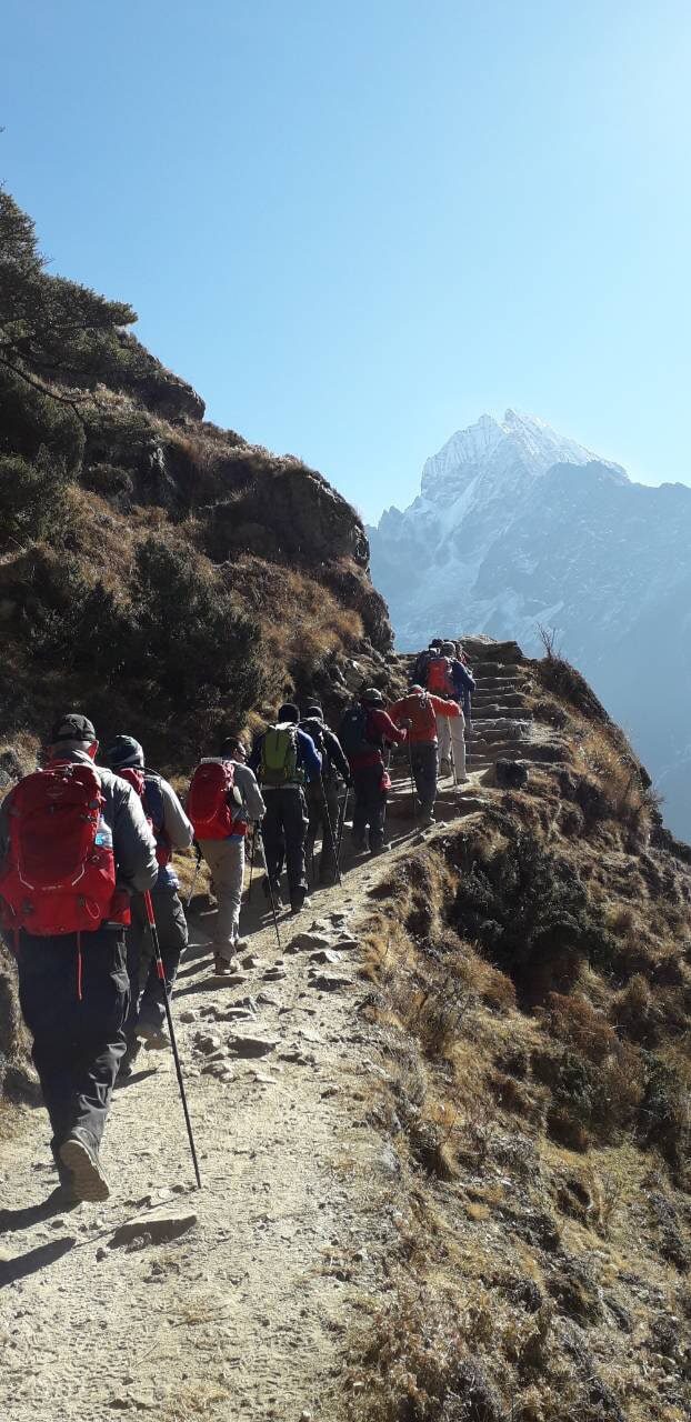 Trekkers in line on the Everest Base Camp trail Nepal moving through the Khumbu valley