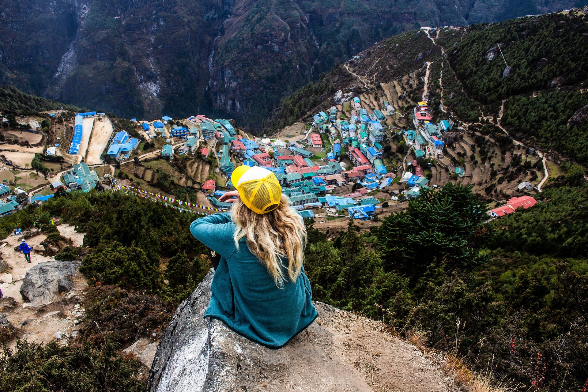 Female trekker looking out over Namche Bazaar from above, Khumbu Nepal