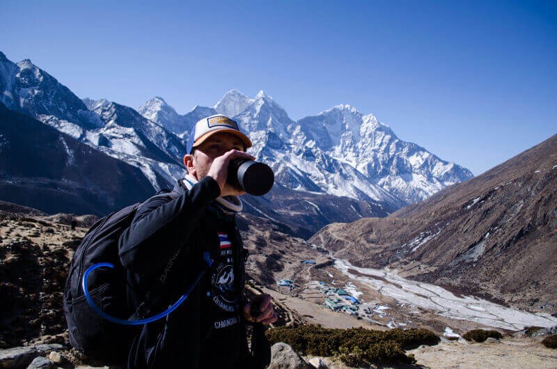 Trekker with a water bottle at Everest Base Camp, Nepal