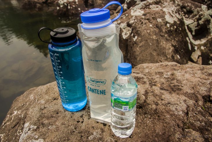 Trekker drinking water on a trail in Nepal